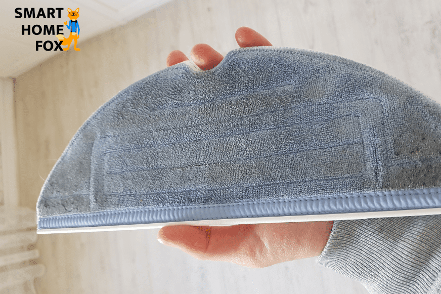 Holding the dirty Roborock S7 mop in the hand